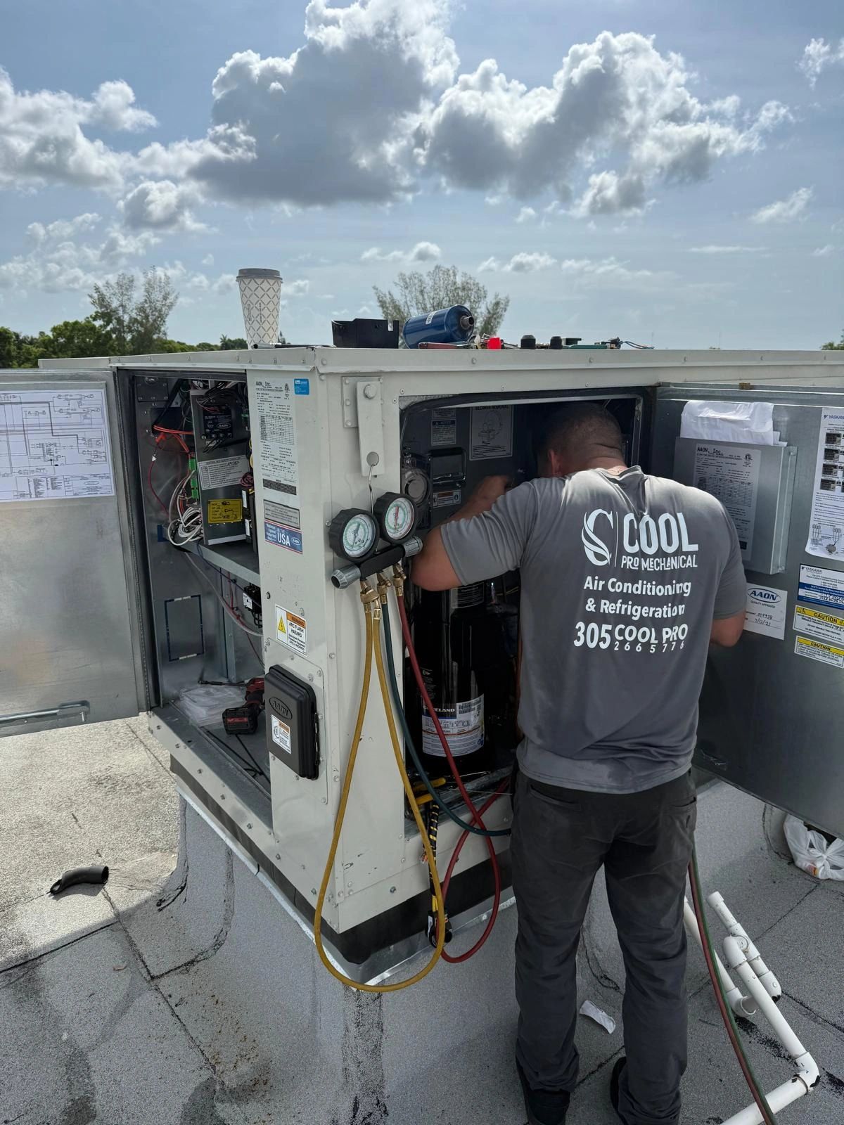 Cool Pro Mechanical technician servicing rooftop AC unit